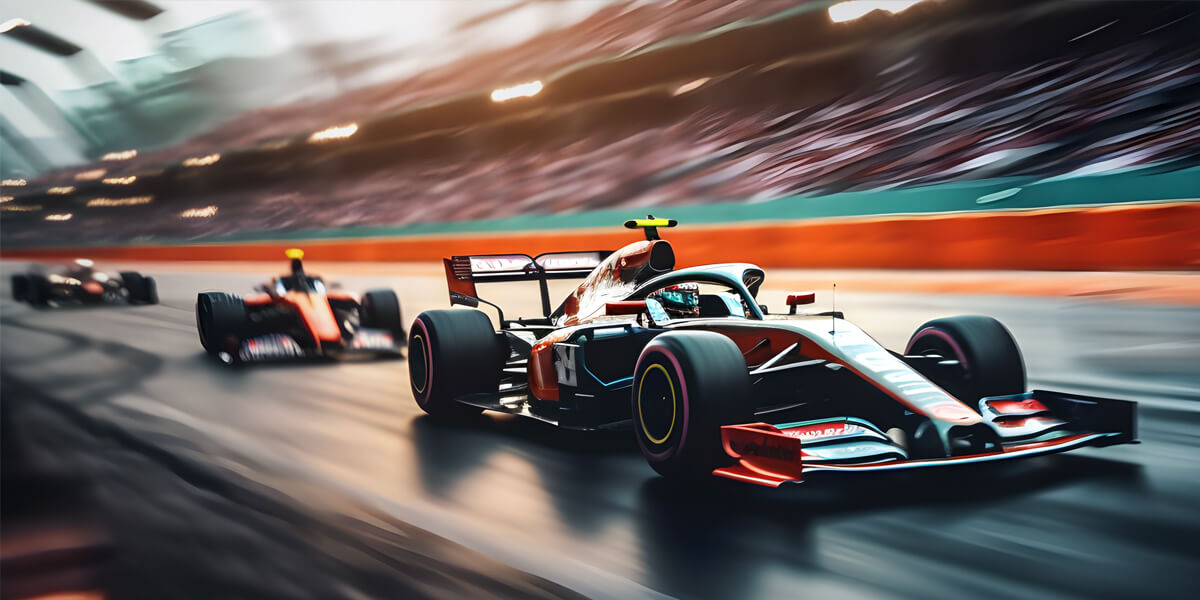 A red and black Formula 1 race car speeds down a track, with motion blur in the background and a crowd watching from the stands.