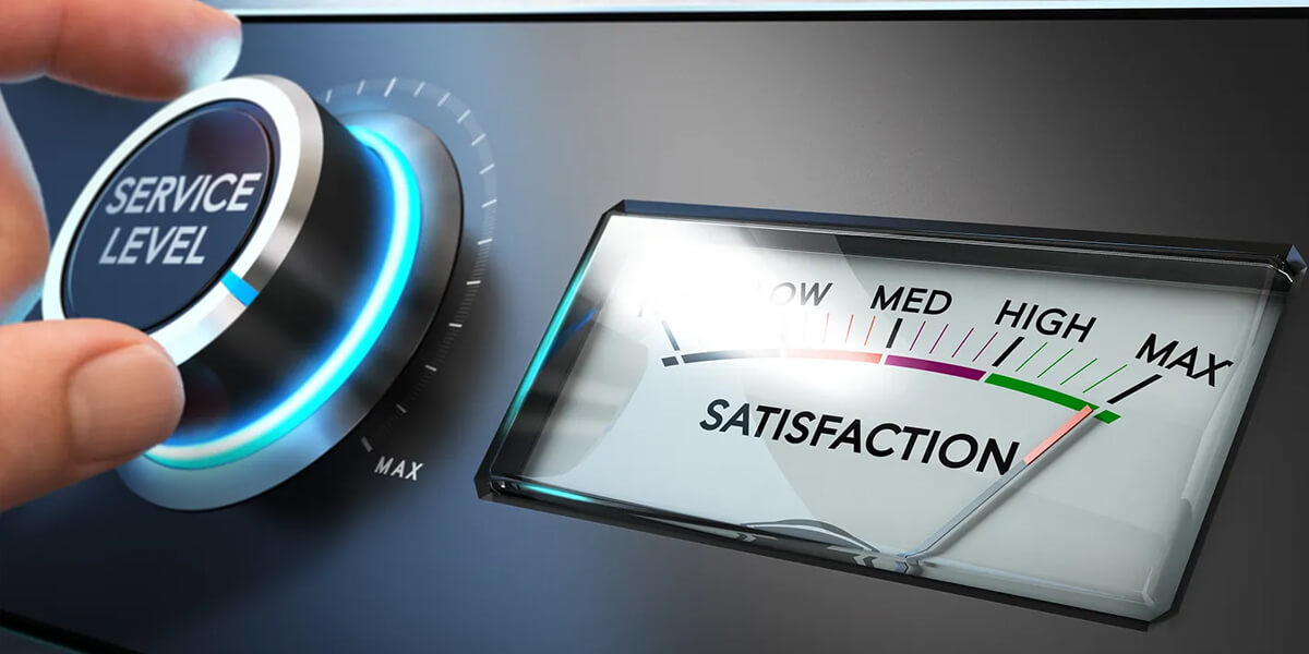A hand turns a large dial labeled Service Level toward maximum, while a nearby gauge with a needle points toward Satisfaction in the high range.