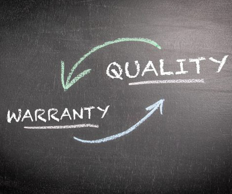 The words WARRANTY and QUALITY are written in white chalk on a blackboard, connected by two curved arrows, one green and one blue, forming a cycle between the two terms—reflecting the assurance of Barrhaven roof warranties.