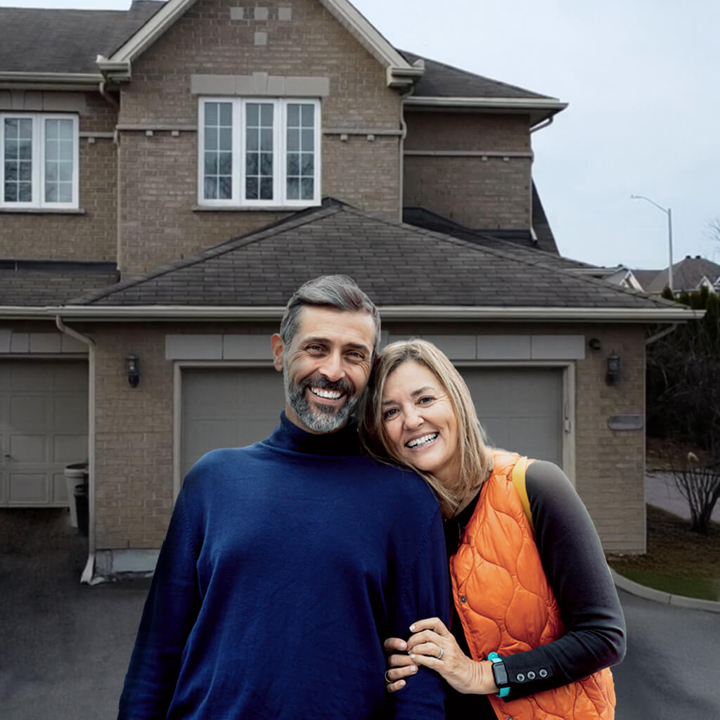 A smiling man and woman stand outside a modern house, holding a cheerful baby. Surrounded by greenery and bright sunlight, the family enjoys their home’s new roof after reading glowing customer reviews on roofing.